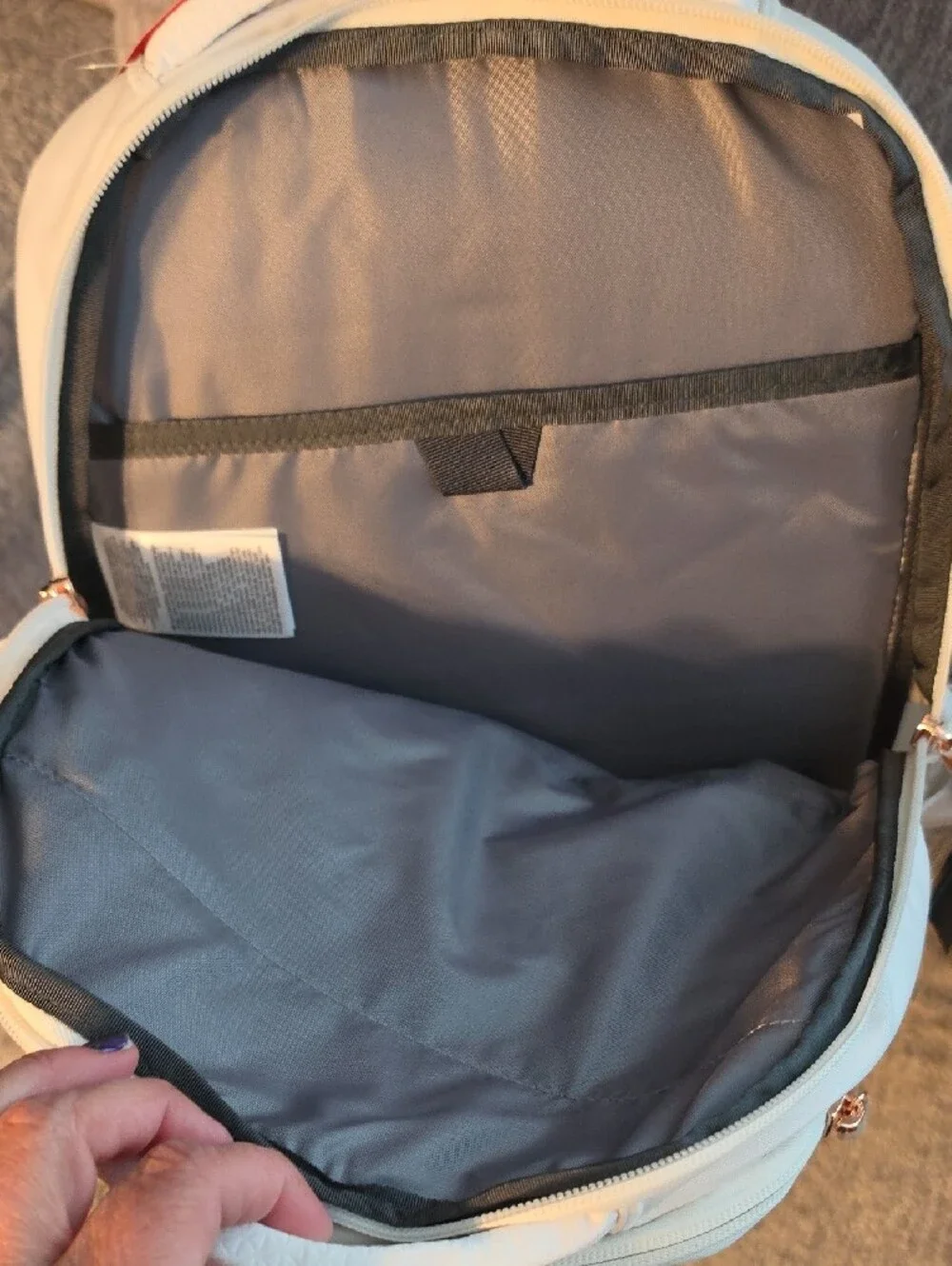 The North Face Jester Luxe Backpack - Cream/Light Beige with Rose Gold Accents.